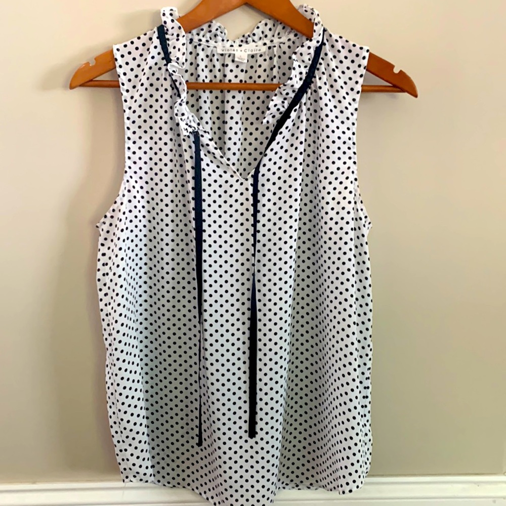 Sleeveless polka dot blouse with ruffled collar. Size L